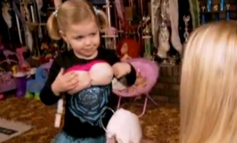 Madisyn Verst, 4, tries on fake boobs as part of her Dolly Parton costume, which was actually her mom&#039;s from her own child pageant days.