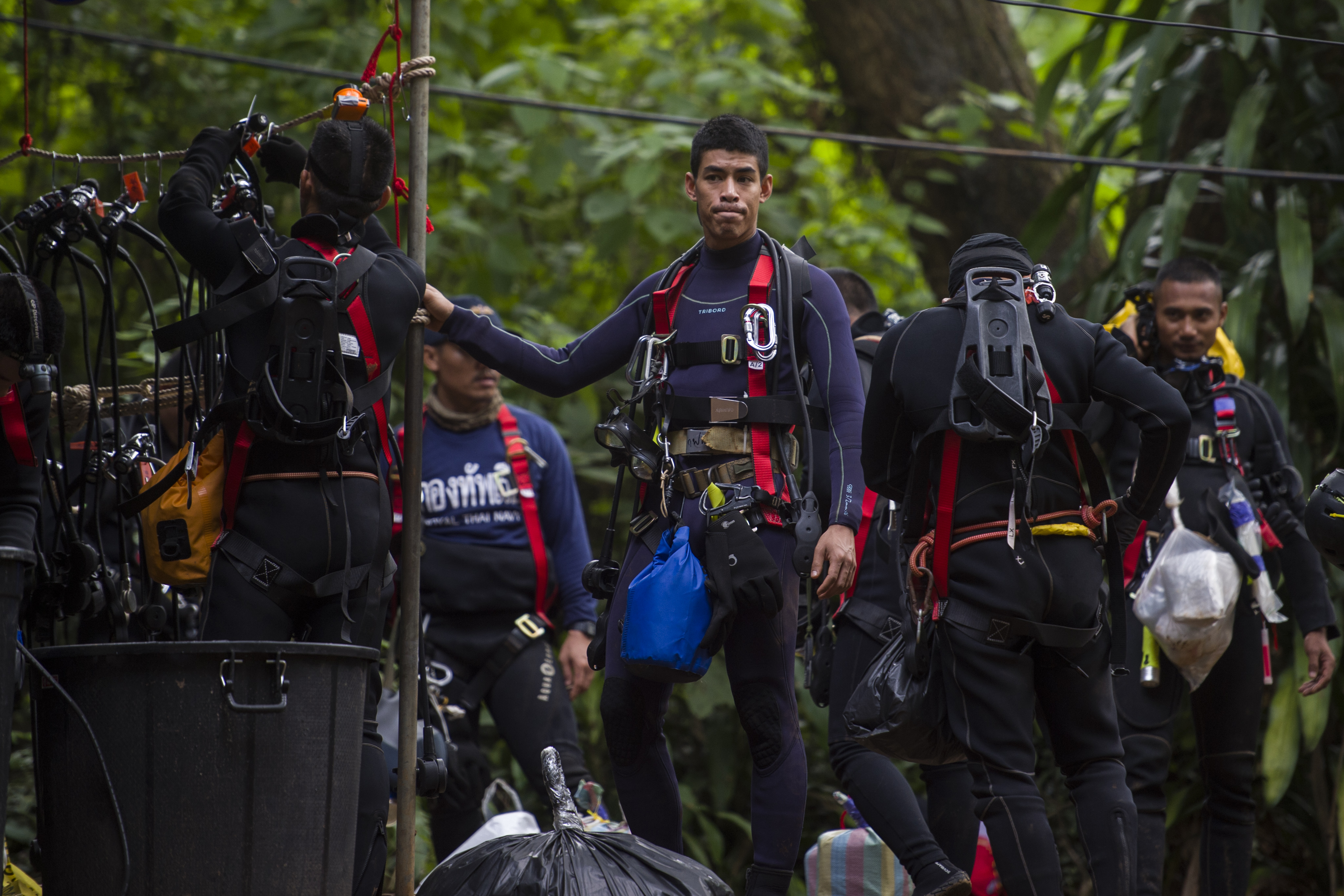 Thai divers carry supplies as rescue operations continue for 12 boys and their coach trapped at Tham Luang cave at Khun Nam Nang Non Forest Park in the Mae Sai district of Chiang Rai province