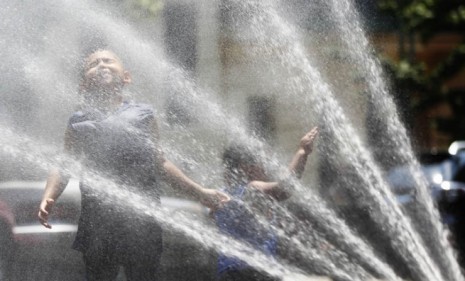 Children cool off in the Bronx borough on Tuesday: A stifling heat wave has sent temperatures skyrocketing throughout the country.