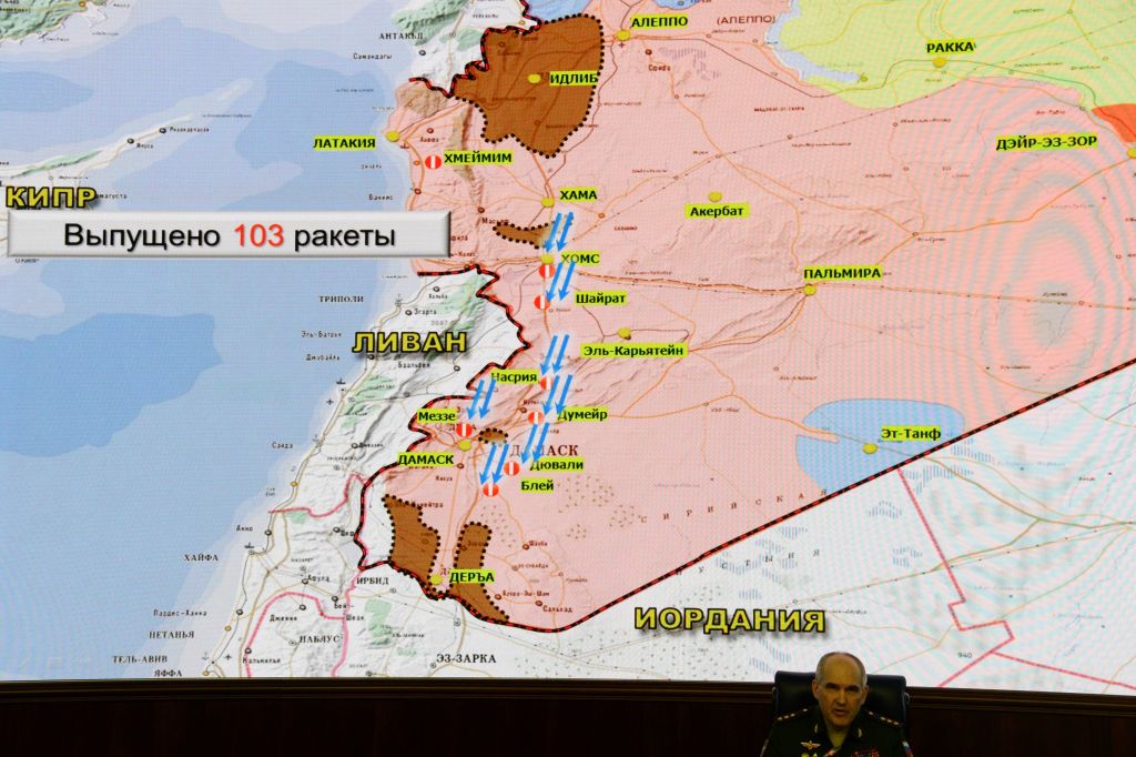 Russia&#039;s senior military officer Sergei Rudskoi sits bellow a map of Syria screened during a briefing at the Russian Defence Ministry headquarters in Moscow on April 14, 2018, following overn
