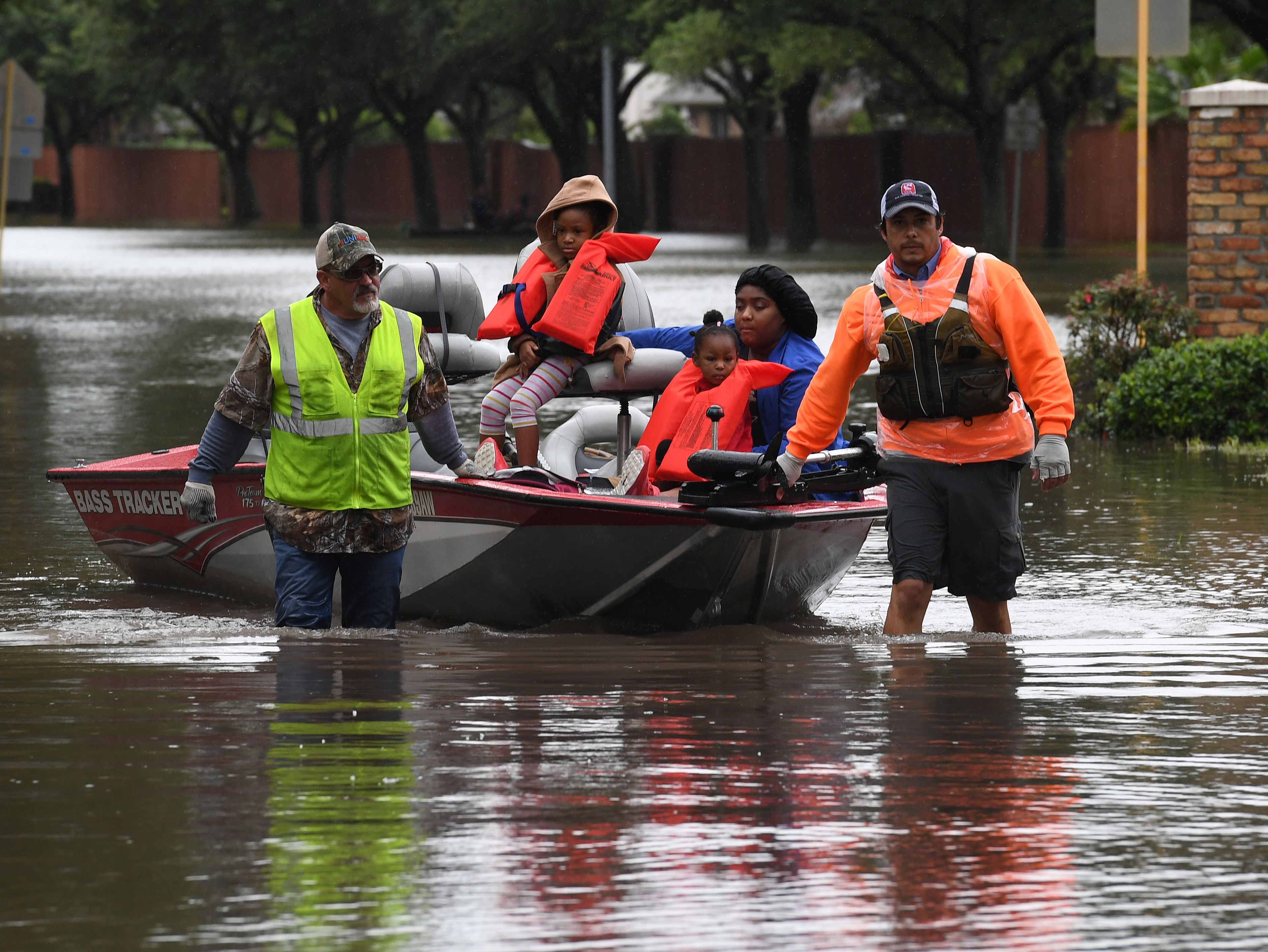 Houston residents are evacuated from Tropical Storm Harvey flood waters by volunteers.