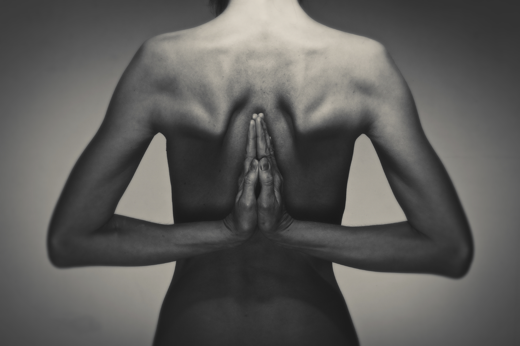 A woman tries yoga sans clothing. 