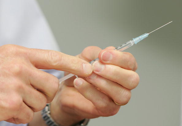 A doctor prepares a vaccination.