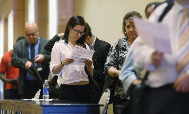 Job seekers wait in line to attend a Long Island job fair on May 2 in New York.