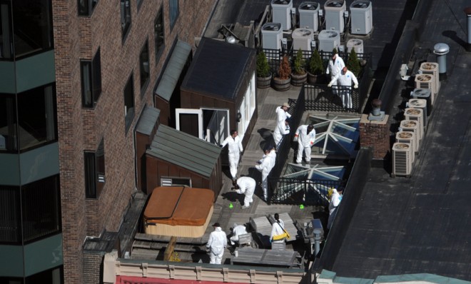 Crime scene investigators inspect a rooftop on April 18, above the site of the bombing on Boylston Street.