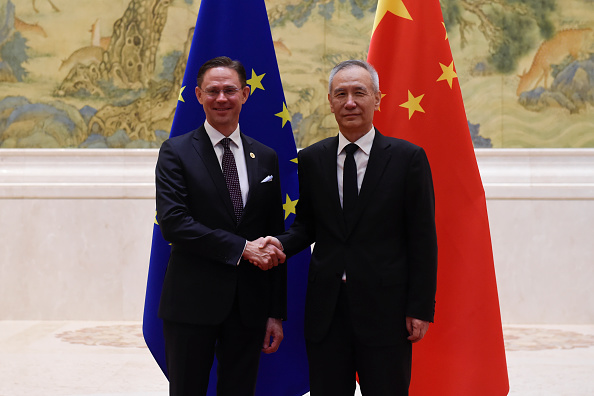 European Commission Vice President Jyrki Katainen stands with Chinese Vice Premier Liu He.