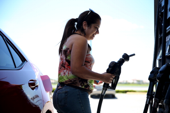 A woman fills up her gas tank.