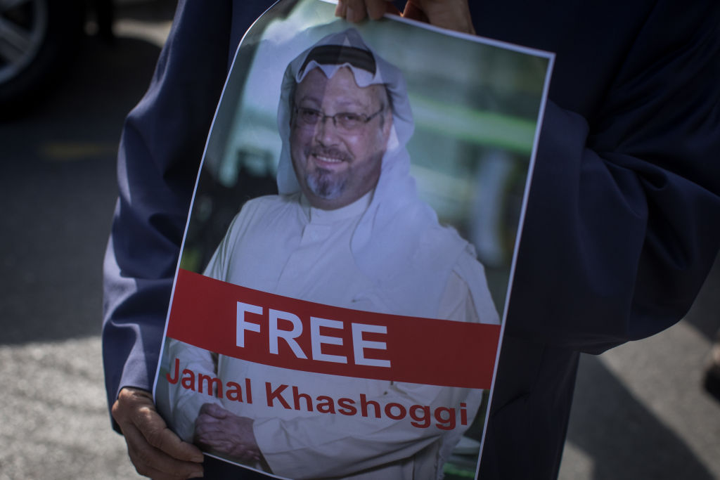 People hold posters of Saudi journalist Jamal Khashoggi during a protest organized by members of the Turkish-Arabic Media Association at the entrance to the Saudi Arabia Consulate on October 