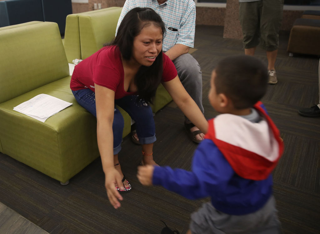 A migrant mother is reunited with her son in Texas