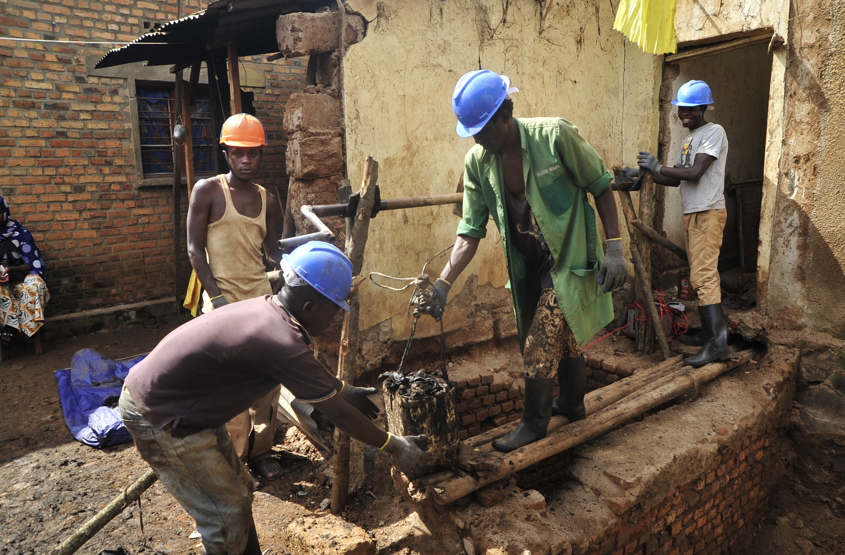 Residents excavate a newly discovered mass grave in Rwanda.