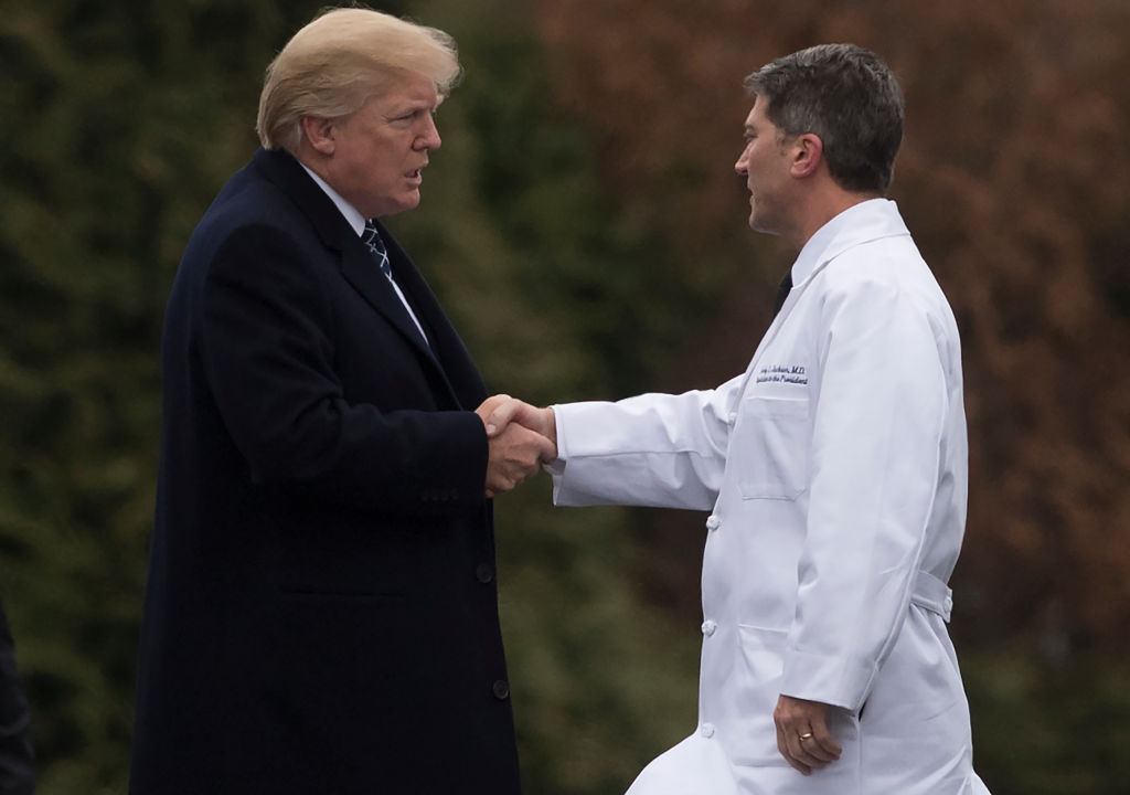 Donald Trump shakes hands with Ronny Jackson.