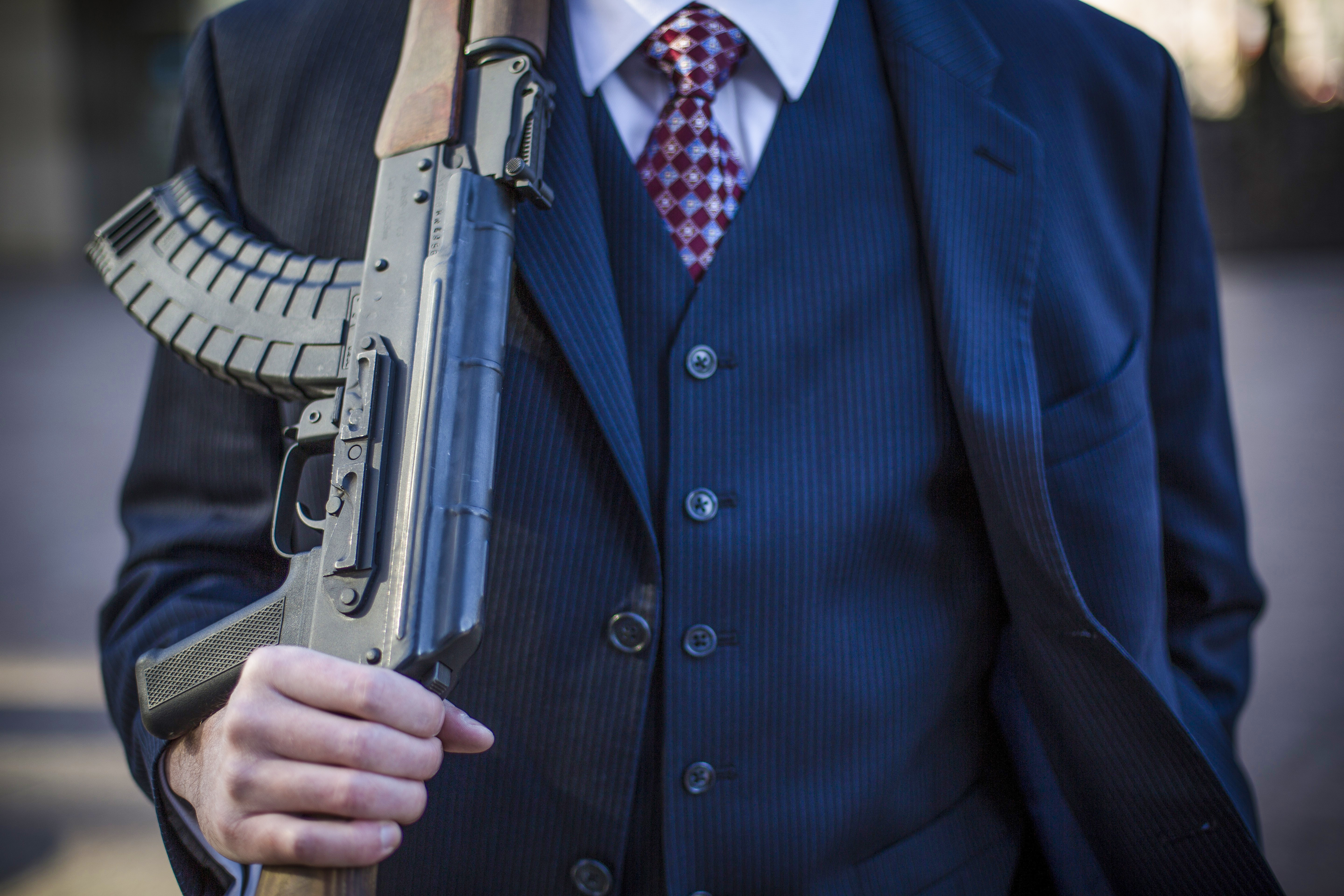 A gun-rights supporter shoulders his AK-47 during a protest.