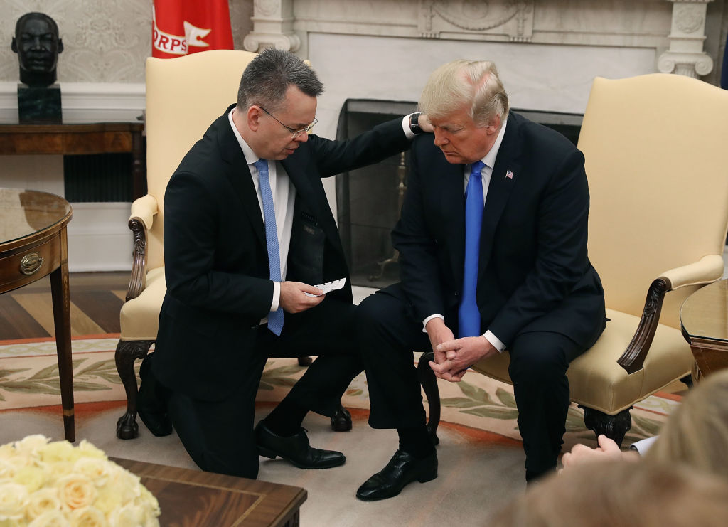 Evangelical pastor Andrew Brunson prays over Trump in the Oval Office