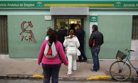 People file into a government job center in Chipiona: Spain has the largest unemployment rate in the eurozone, which is only hurting the country&#039;s crippling debt problem.