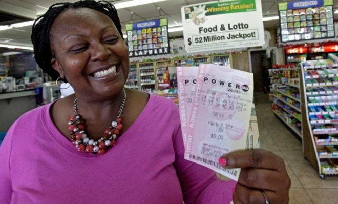 Felicia Ross flashes a winning smile in Orlando, Fla., while showing off Powerball tickets that probably won&#039;t win.