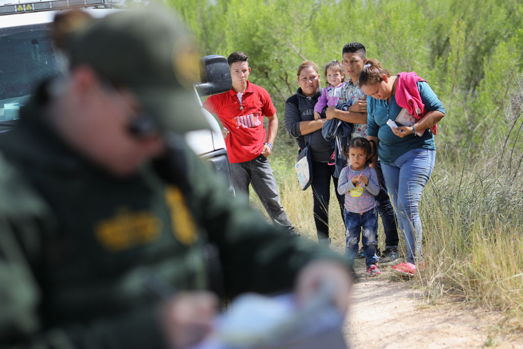 Asylum-seekers from Central America with a Border Patrol agent.