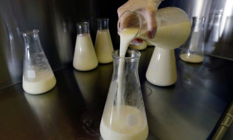 A lab technician at the Mothers&#039; Milk Bank of New England in Newtonville, Mass., pours donated breast milk as it&#039;s prepped for pasteurization: Last year, the nation&#039;s largest milk bank group 