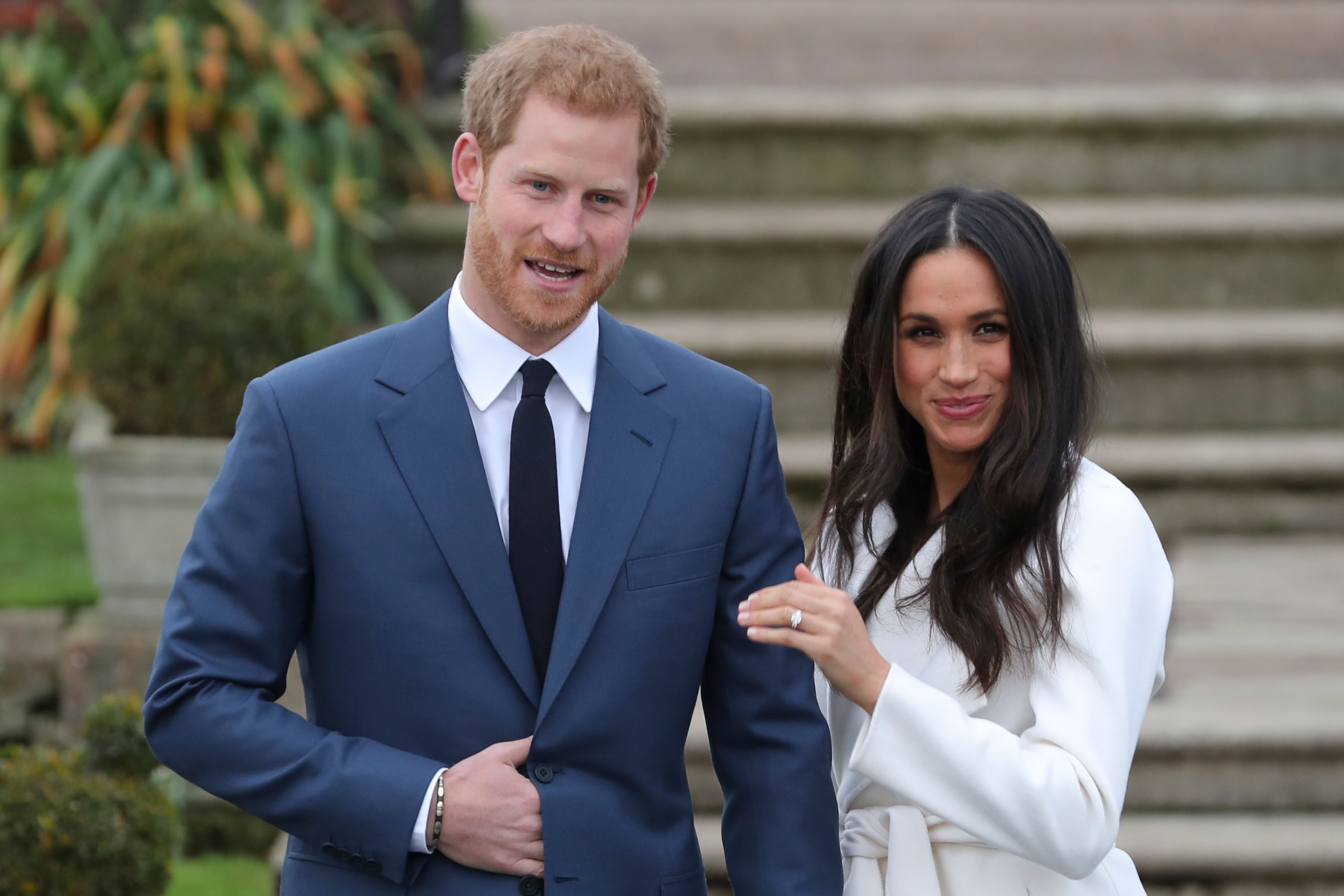 Prince Harry stands with his fiancée US actress Meghan Markle. 