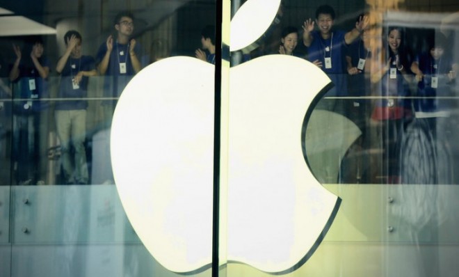 Apple staff members cheer before the Oct. 20 opening of the new Apple store in Wangfujing shopping district in Beijing.