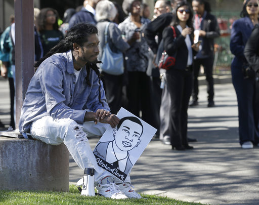 A demonstrator holds a drawing of police shooting victim Stephon Clark in Sacramento.