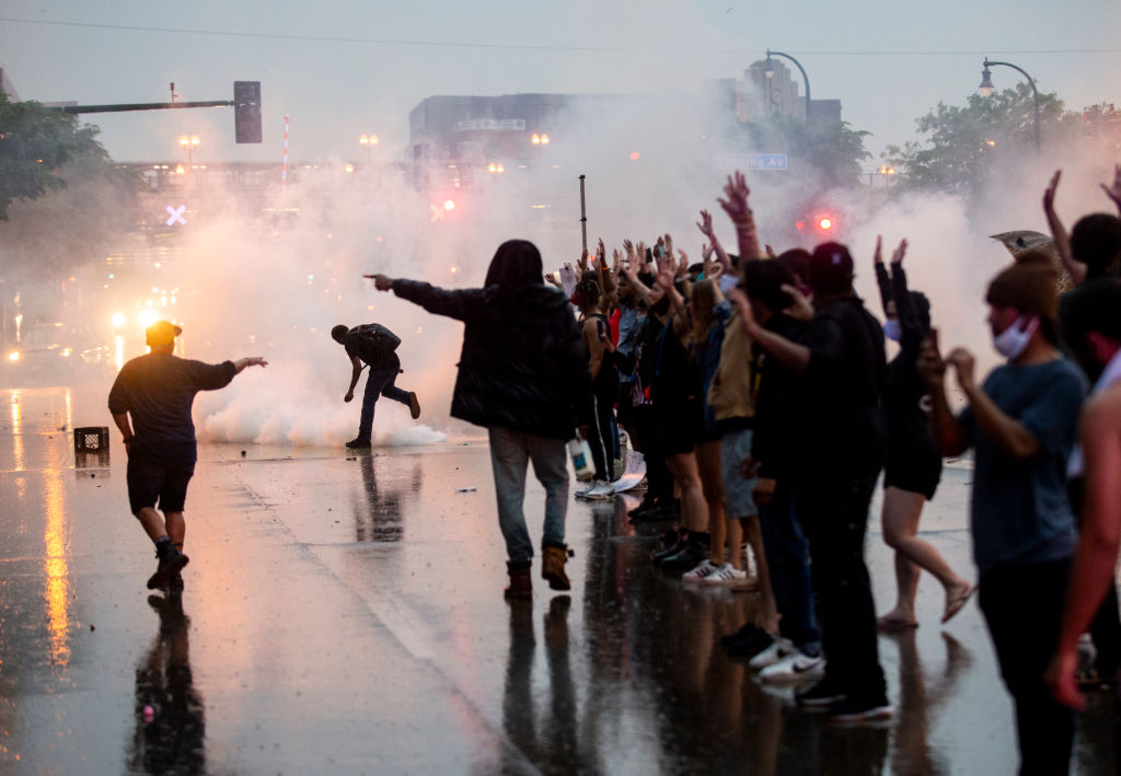 Tear gas is fired at protesters.