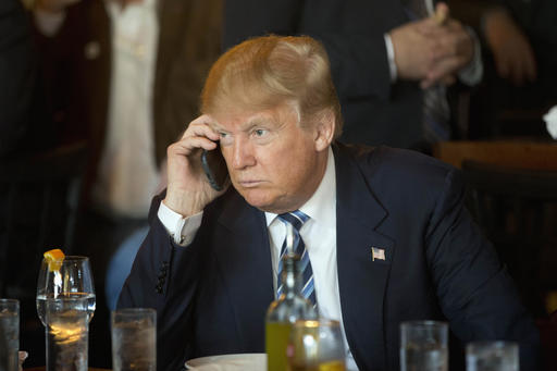 Trump talks on a smartphone in 2016
