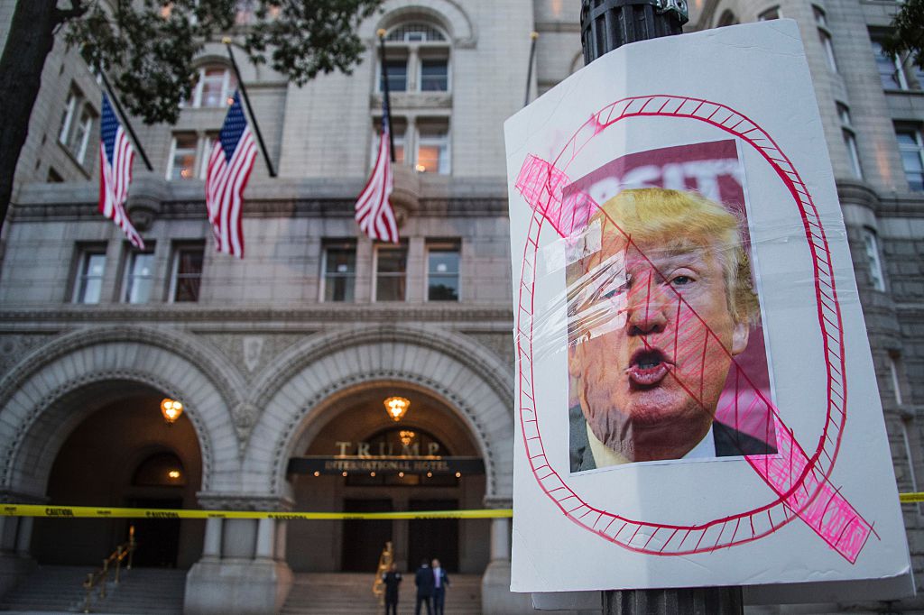 An anti-Trump sign in front of newest Donald Trump hotel
