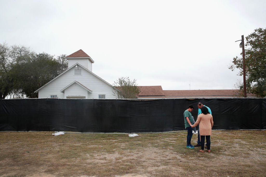 People pray outside of the Baptist church in Sutherland Springs, Texas.