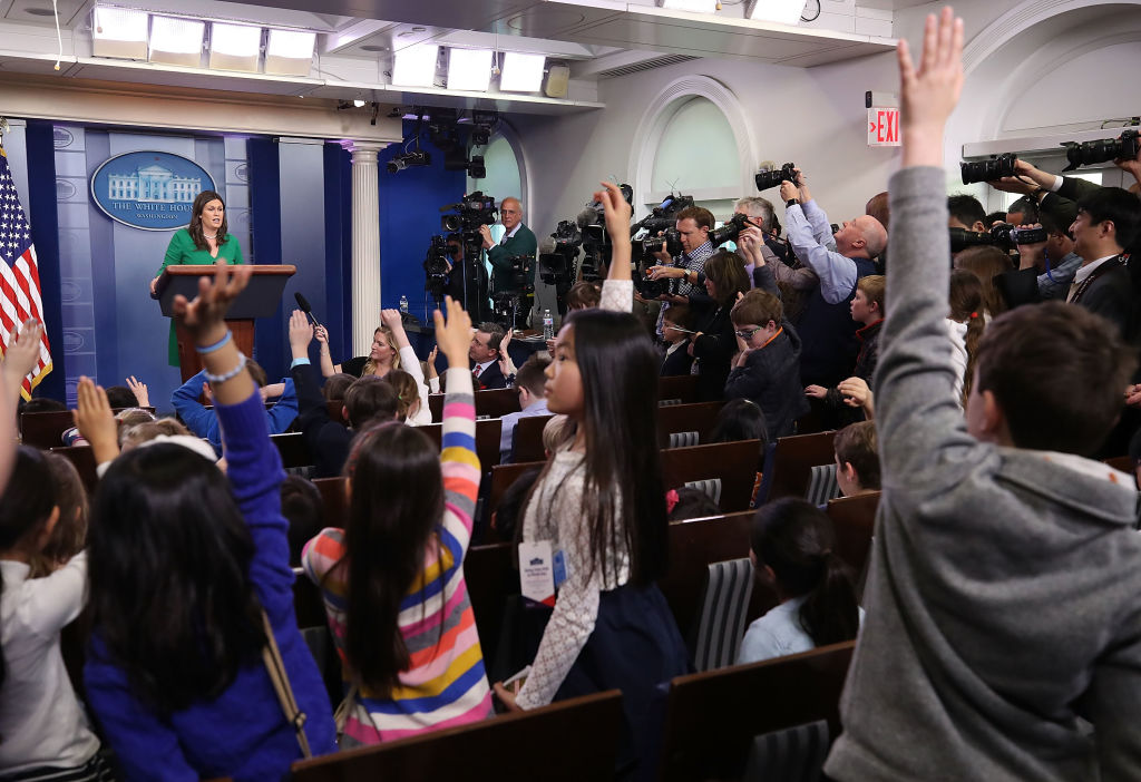 Sarah Huckabee Sanders takes questions from children at a mock briefing.