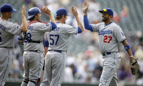 Members of the Los Angeles Dodgers high five after a winning game this summer: A fellow Dodgers player invented the congratulatory gesture 34 years ago.