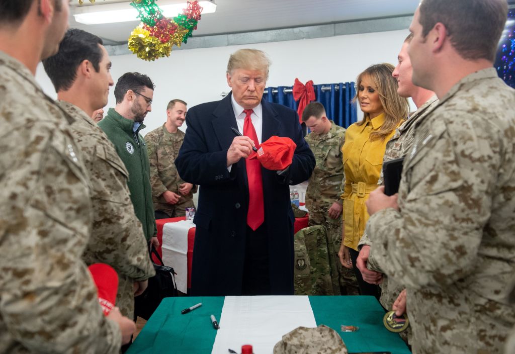 Trump signs a campaign hat in Iraq