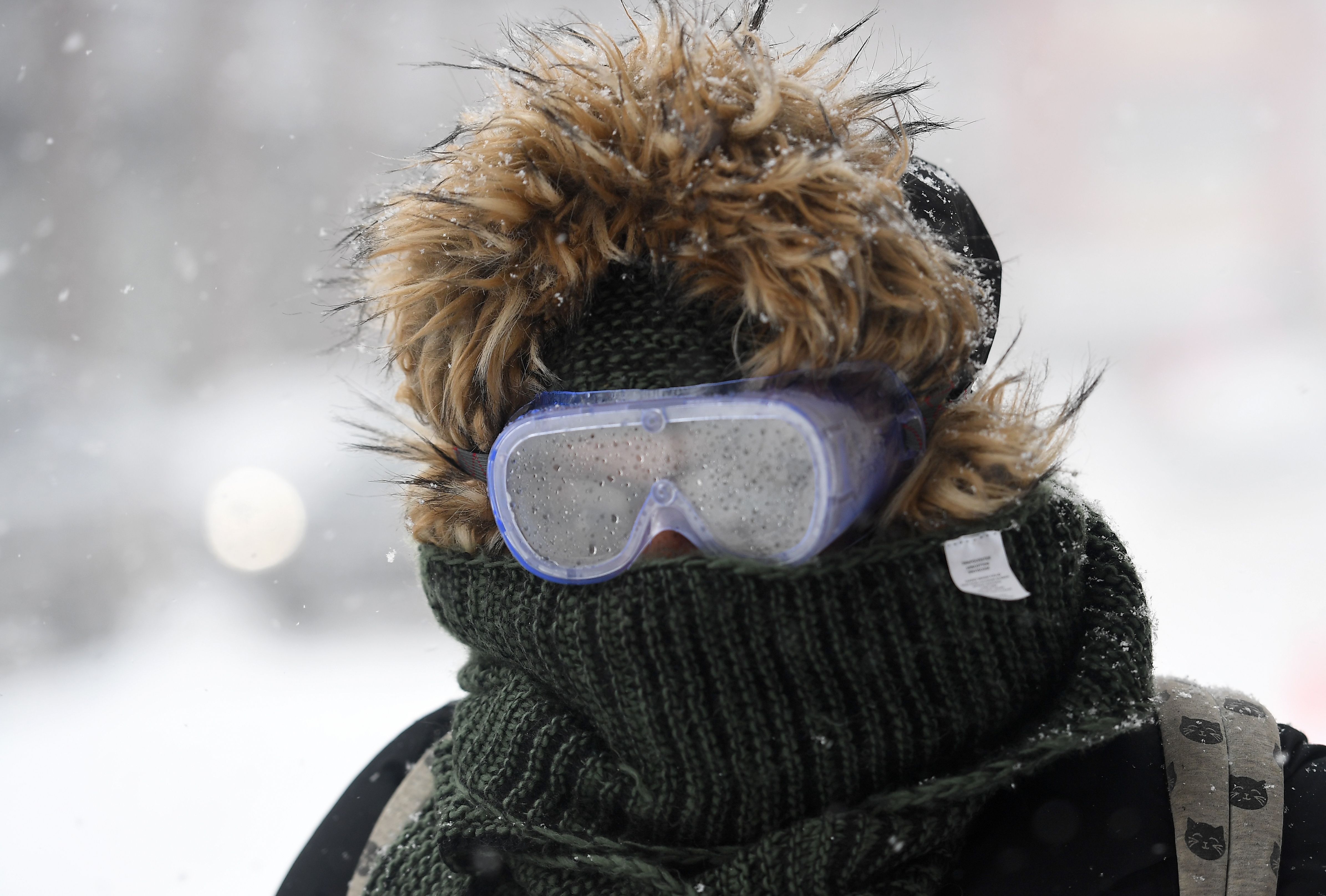 A New Yorker wears goggles in a snowstorm
