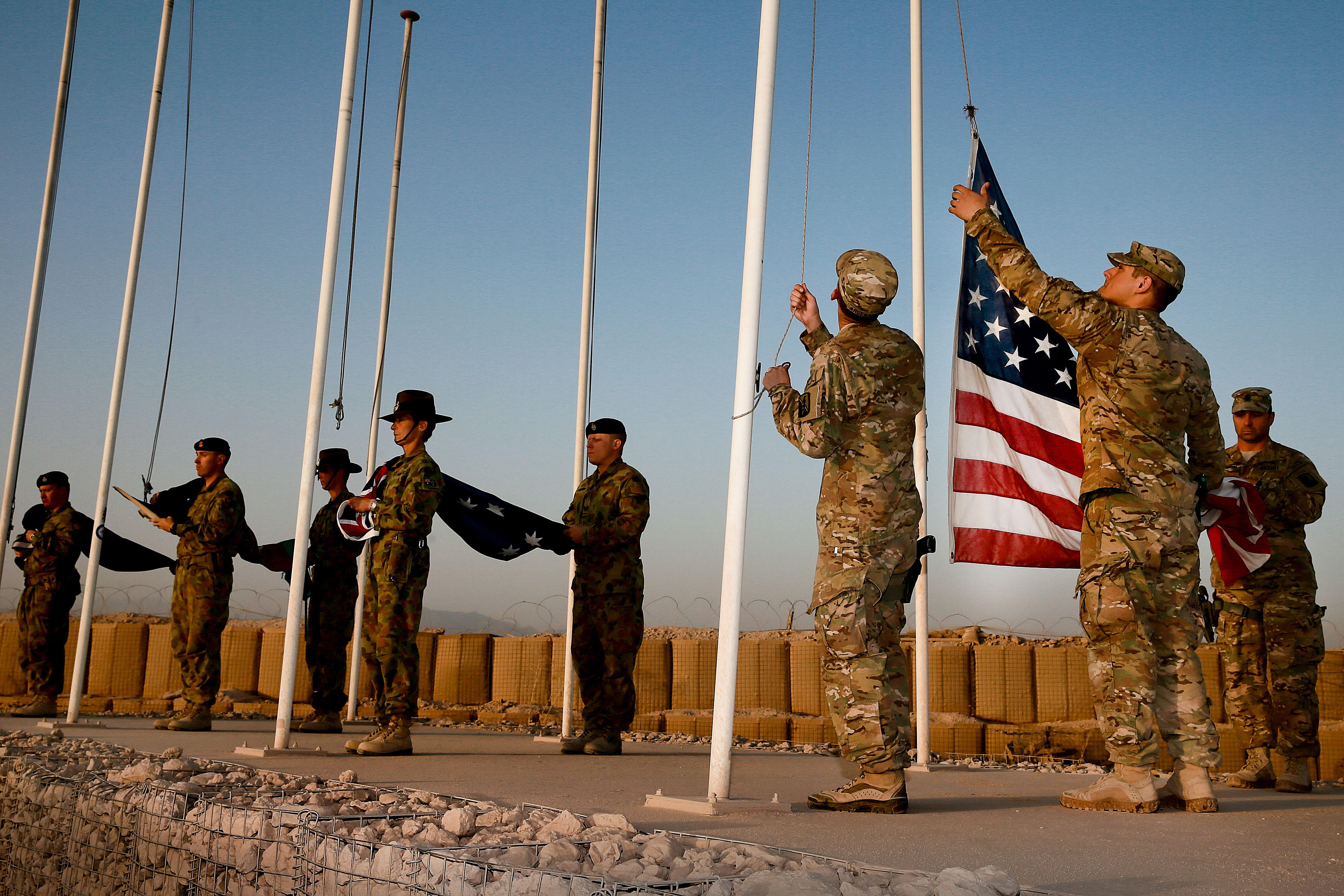 American military lower the American flag at a base in Afghanistan.