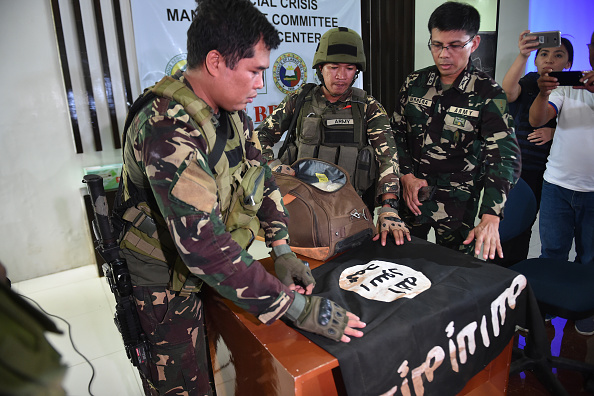 Police in the Philippines with an ISIS flag they found.