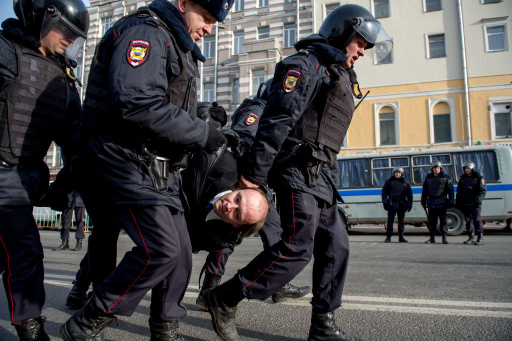 Police arrest a protester in Moscow