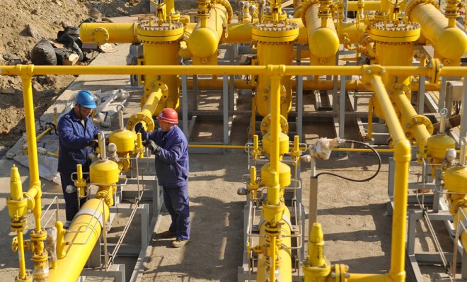 Employees install equipment for natural gas at Dongbel Special Steel Group Co., Ltd in Dallan, Liaoning province, China, on March 6.