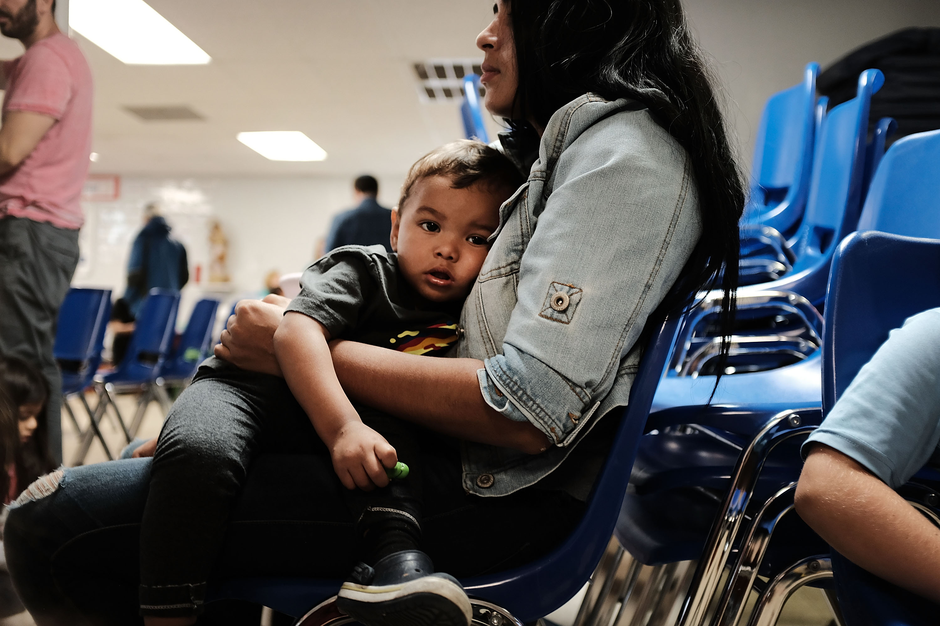A woman who idendtified herself as Jennifer sits with her son Jaydan at the Catholic Charities Humanitarian Respite Center after recently crossing the U.S., Mexico border on June 21, 2018 in 