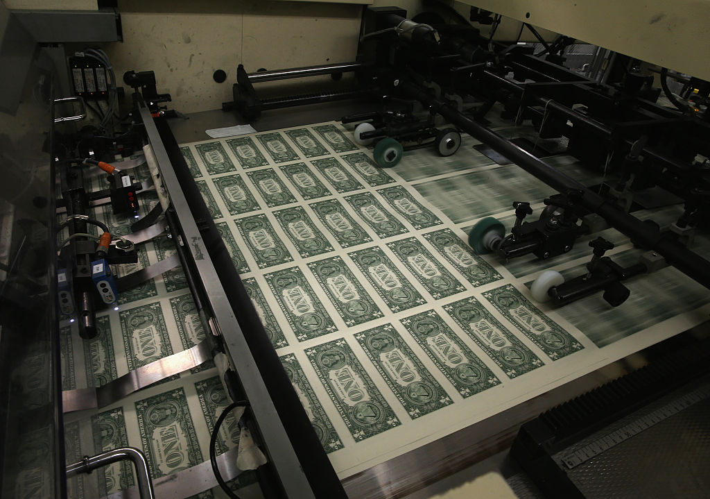 One dollar bills on a printing machine.
