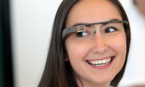 A Google employee wears a pair of Google Glass specs during the company&#039;s Developers Conference on June 27: The high-tech glasses are expected to hit the market in 2014.