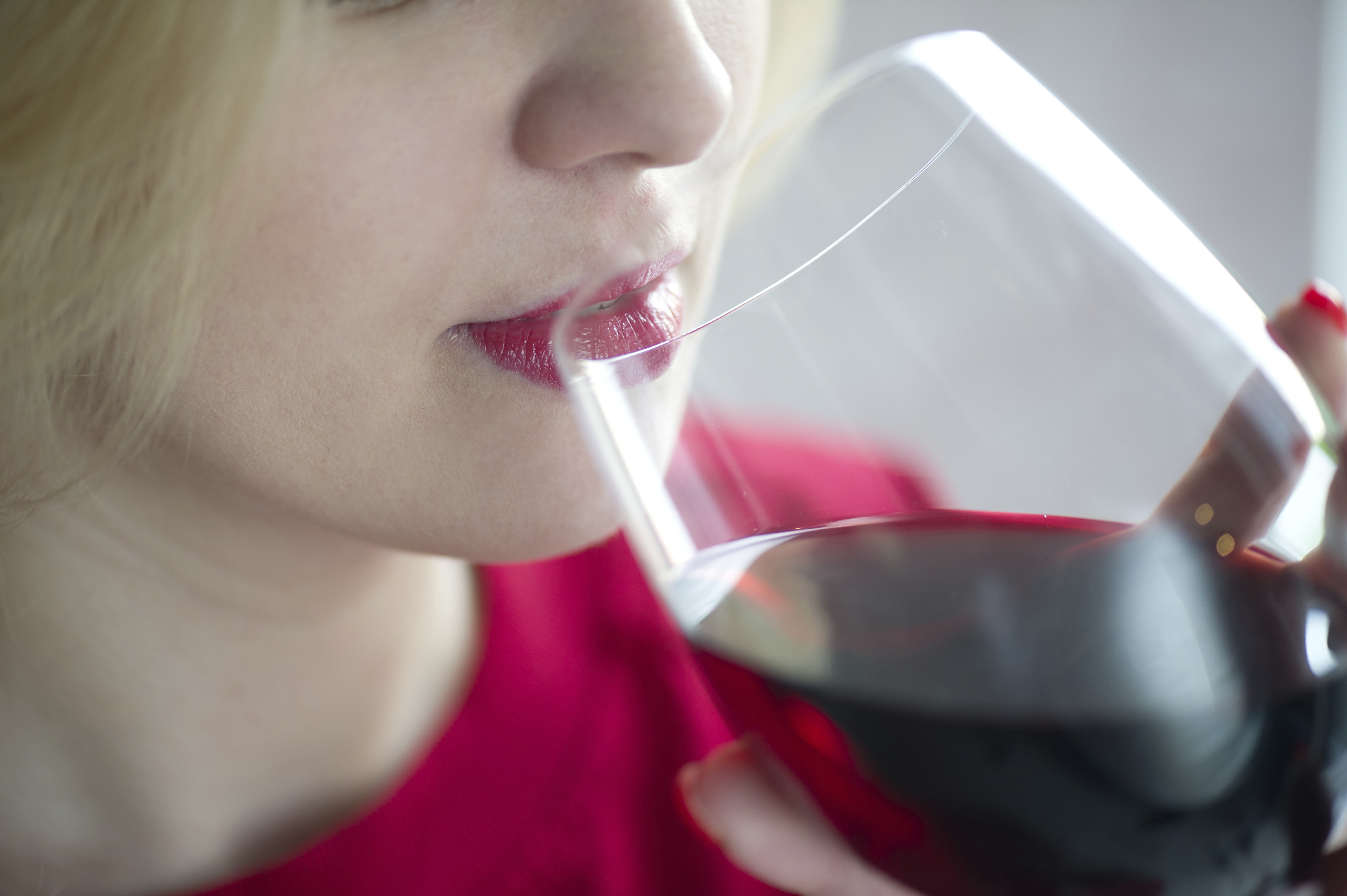Woman drinking a glass of wine.