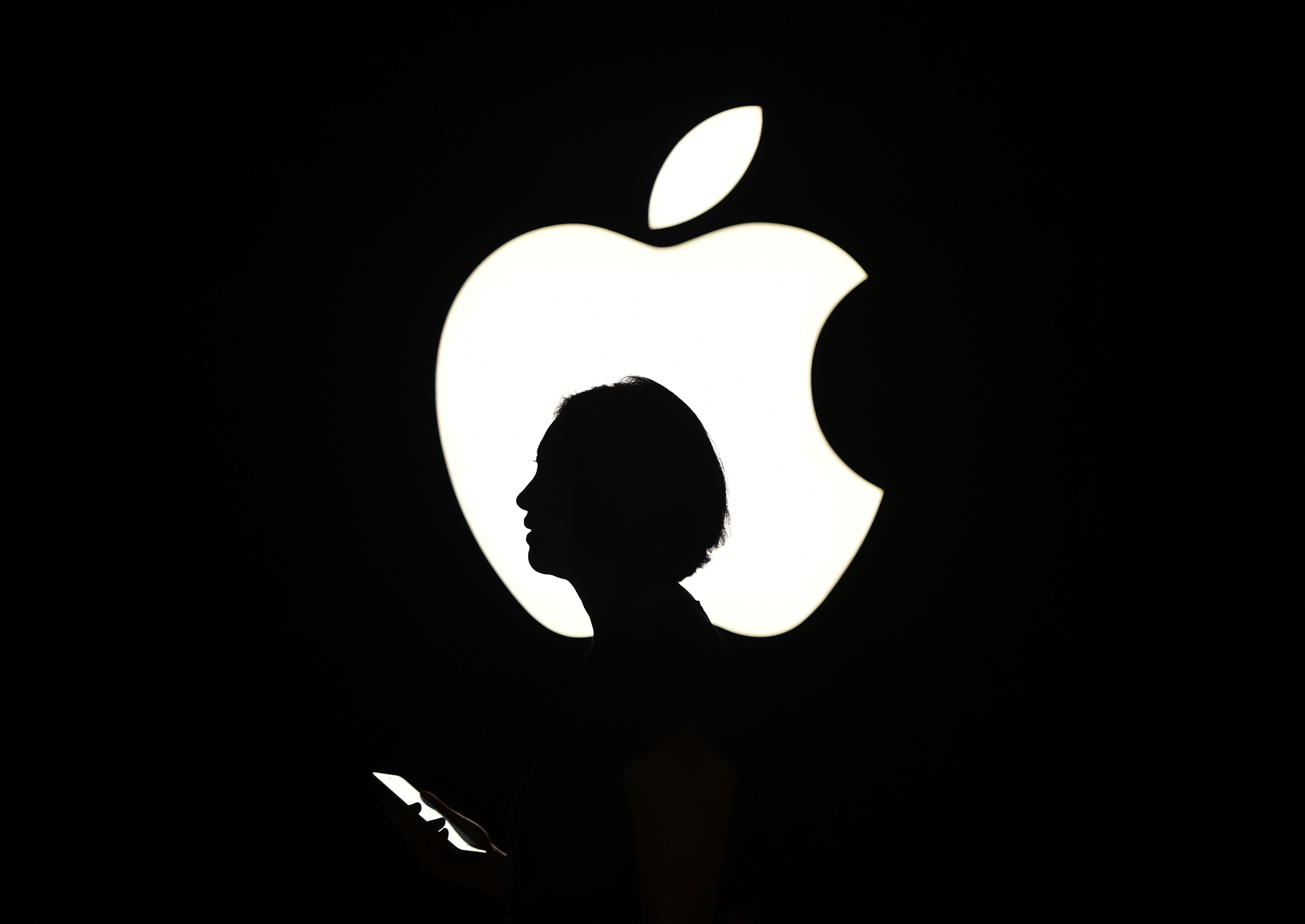 An Apple logo and a woman&#039;s silhouette 