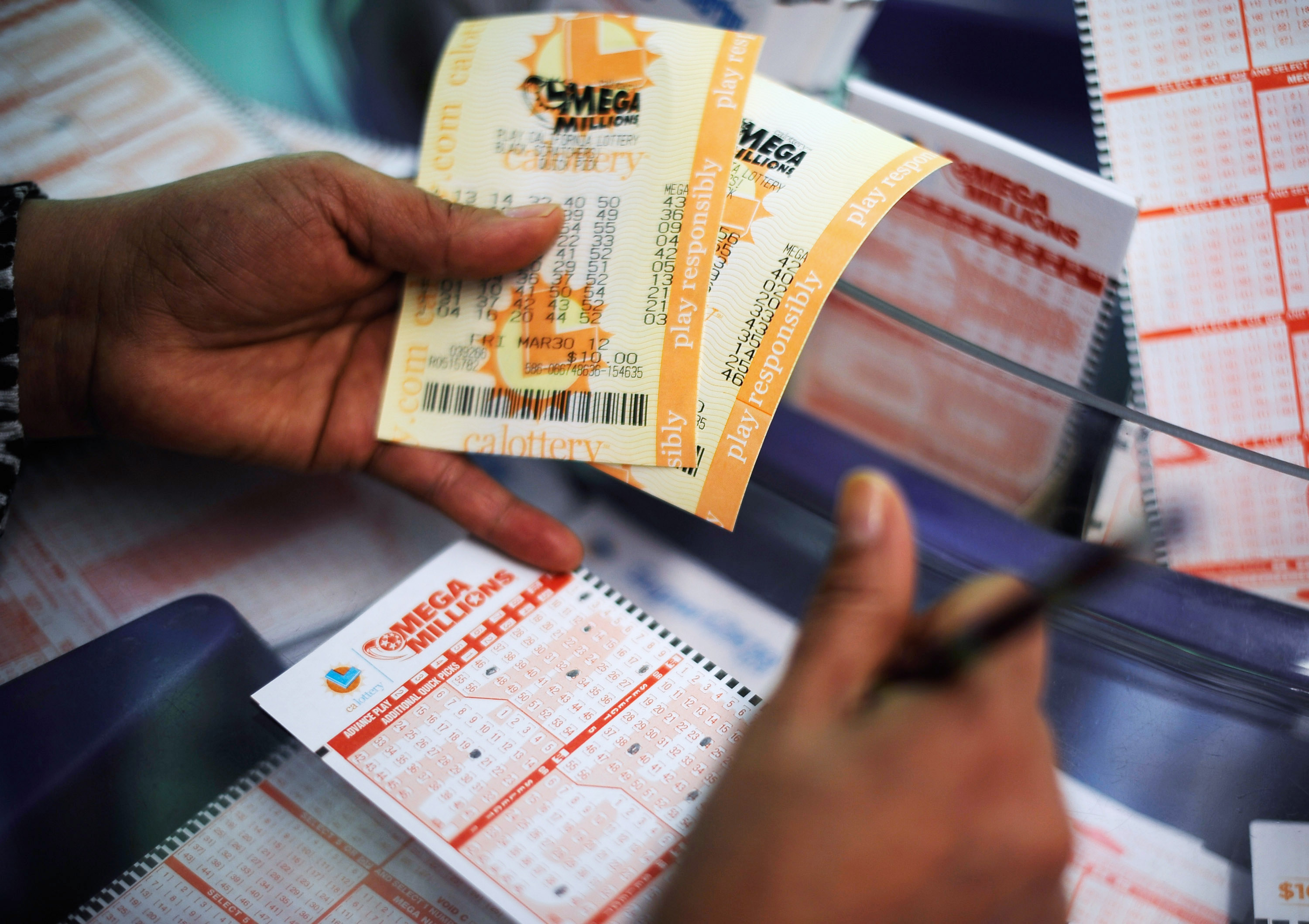 A person holds a Mega Millions ticket.