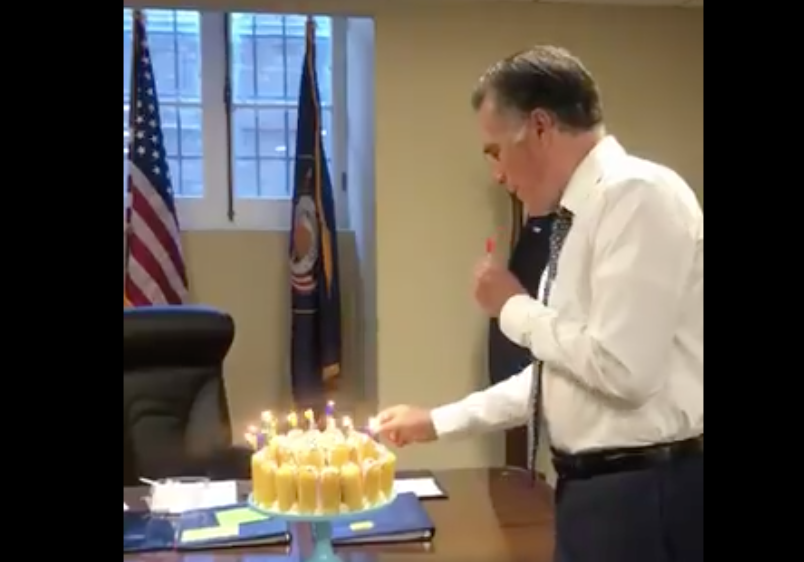 Mitt Romney incorrectly blowing out birthday candles.