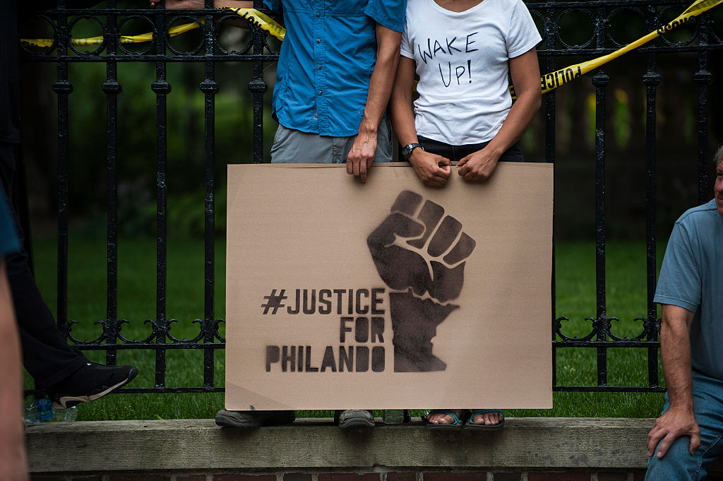 A protester holds a sign reading, &quot;Justice for Philando&quot;