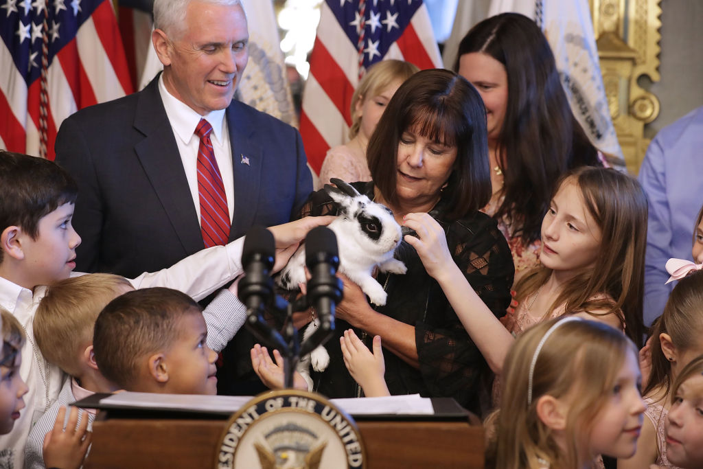 Mike Pence and his family pet their rabbit.