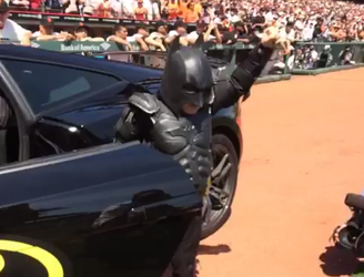 Batkid cruises up in a Ferrari to throw the first pitch at a San Francisco Giants game
