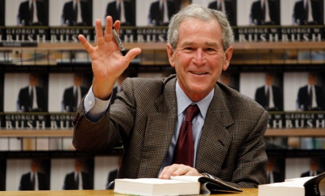 Former President George W. Bush waves while signing copies of his memoir Decision Points in Dallas in 2010.  