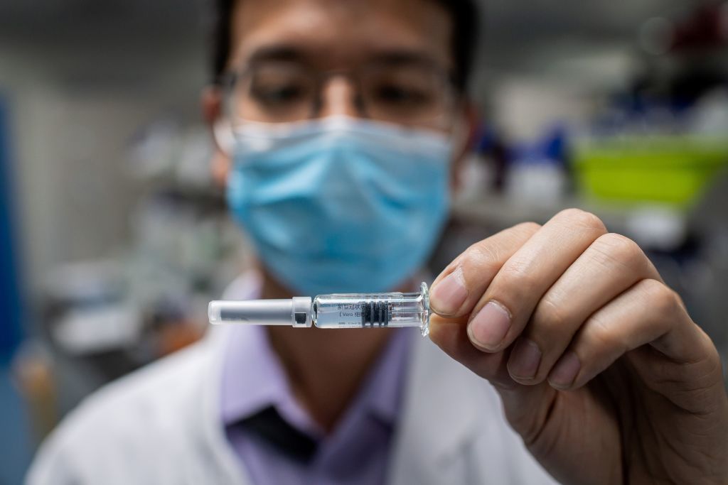 In this picture taken on April 29, 2020, an engineer shows an experimental vaccine for the COVID-19 coronavirus that was tested at the Quality Control Laboratory at the Sinovac Biotech facili