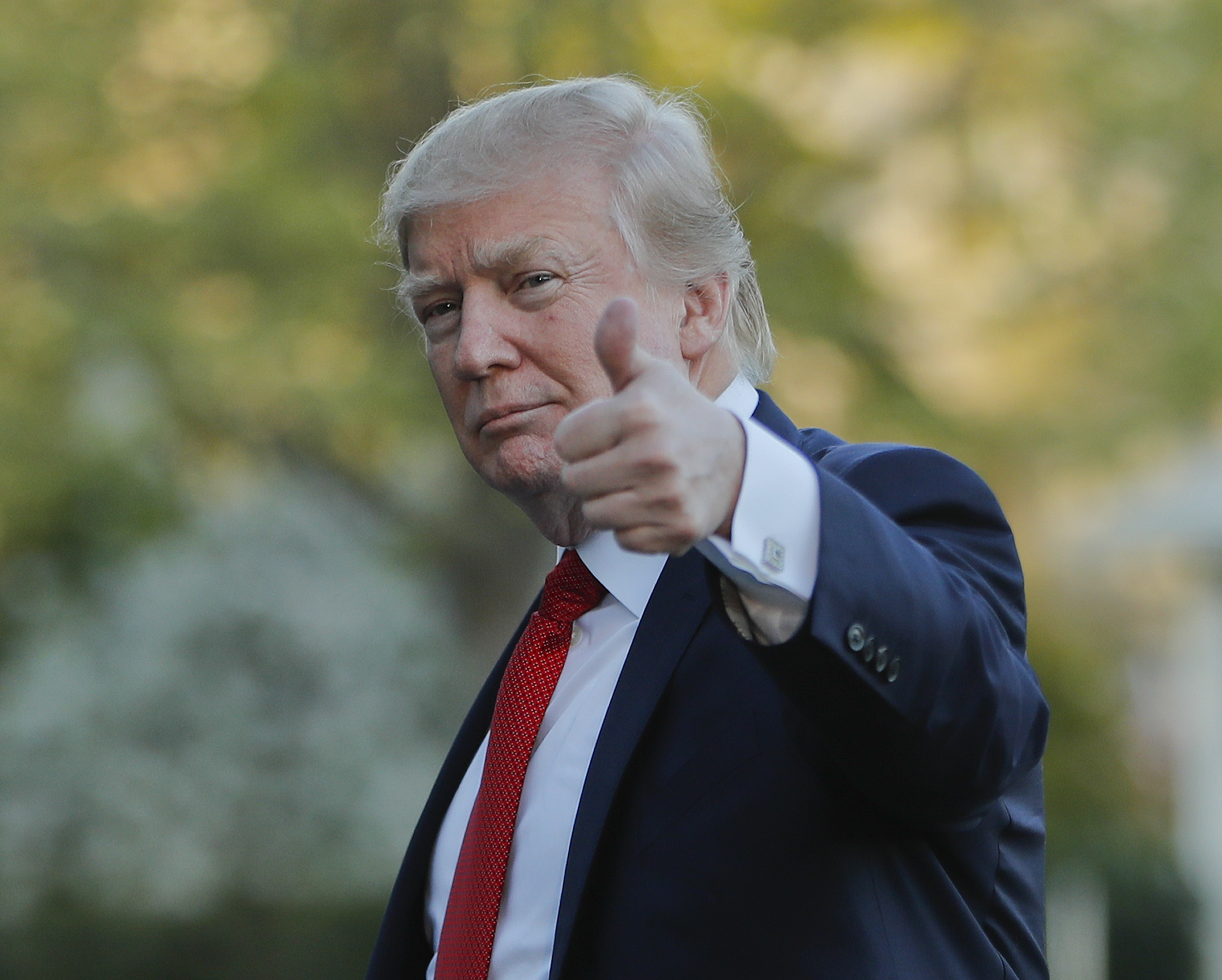 President Trump gives a thumbs-up on the way to Mar-a-Lago
