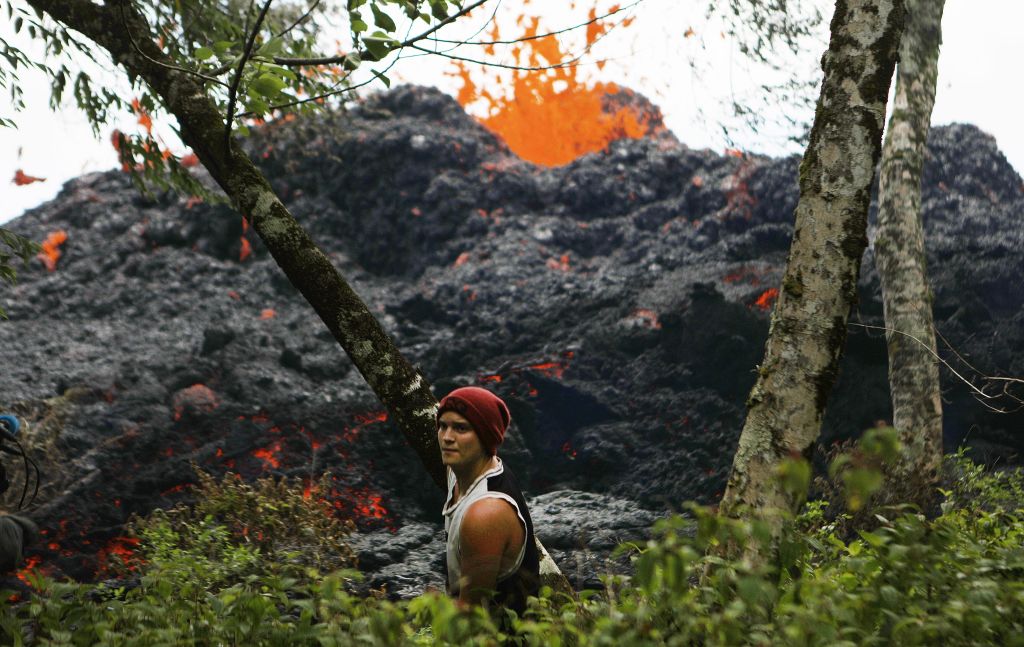 A lava fissure erupts as a resident stands nearby in the aftermath of eruptions from the Kilauea volcano on Hawaii&#039;s Big Island, on May 12, 2018 in Pahoa, Hawaii.